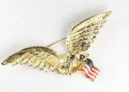 goldtone eagle in flight with flag